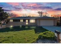 Charming single-story brick home with a well-manicured lawn and a two-car garage at 772 Urban Ct, Lakewood, CO 80401