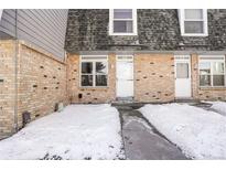 Brick townhouse exterior with snow-covered walkway at 1557 S Owens St # 59, Denver, CO 80232