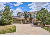 Beautiful two-story home features a stone and siding exterior, a three-car garage, and well-maintained landscaping at 282 N De Gaulle St, Aurora, CO 80018