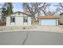 Quaint single-Gathering home with detached garage, cream-colored exterior, and large trees at 9340 Pierce St, Westminster, CO 80021