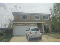 Charming stucco two-story home with a tile roof, attached garage, and well-maintained front yard at 3811 Lisbon Ct, Denver, CO 80249