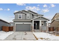 Two-story house with gray siding, attached garage, and small front porch at 46545 Orchard Dr, Bennett, CO 80102