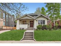 Charming bungalow with inviting front porch and well-manicured lawn at 853 Saint Paul St, Denver, CO 80206