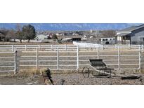 Ranch property with white fencing, horse trailer, and mountain views at 1751 E 138Th Ave, Brighton, CO 80602