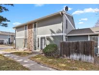 Two-story home featuring stone accents, neutral siding, and a well-kept lawn and walkway at 10001 E Evans Ave # 58B, Aurora, CO 80247