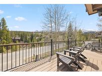 Mountain view from deck with outdoor furniture overlooking green trees at 100 River Park Dr # A, Breckenridge, CO 80424