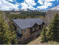 Exterior shot of the home with views of the mountains and evergreen trees at 100 River Park Dr # A, Breckenridge, CO 80424