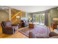 Inviting living room with wood floors, leather furniture, and a walk out to a deck at 100 River Park Dr # A, Breckenridge, CO 80424