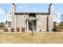 Two story home with a neutral color scheme and a lamp post leading to the main entrance at 4333 S Andes Way # 203, Aurora, CO 80015