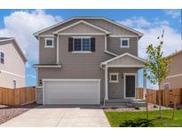 Charming two-story home with a two-car garage and a well-maintained front lawn and beautiful curb appeal at 48250 Shetland Dr, Bennett, CO 80102