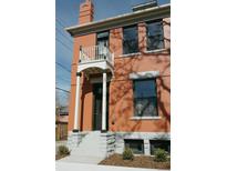 Charming red brick two-story home with a lovely front porch and classic architectural details at 817 29Th St, Denver, CO 80205