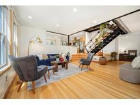 Bright living room with hardwood floors, recessed lighting, modern decor, and staircase at 2937 Champa St # A, Denver, CO 80205