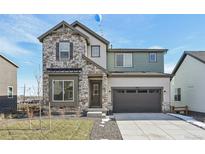 Beautiful two-story home featuring stone accents, a two-car garage, and a well-maintained front yard at 5960 S Platte Canyon Dr, Littleton, CO 80123