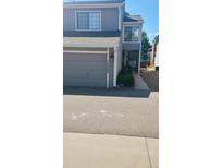Charming two-story townhome with a gray garage and well-maintained landscaping, located in a desirable community at 12592 E Cornell Cir, Aurora, CO 80014