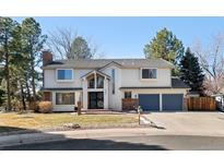 Two-story home boasts a three car garage, charming front yard and brick detailing at 7647 S Crocker Ct, Littleton, CO 80120