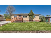 Charming single-story brick home with a cozy front porch and well-manicured lawn at 3871 Moore St, Wheat Ridge, CO 80033