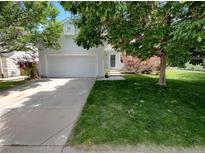 Charming two-story home with a well-maintained lawn and an attached two-car garage at 5966 S Winnipeg St, Aurora, CO 80015