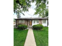 Charming single-story home featuring a stone facade and well-manicured front yard at 3231 S Galapago St, Englewood, CO 80110
