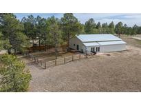 Charming single-Gathering home on a sprawling lot with a metal roof, a fenced in garden, and an outbuilding at 37677 Sable Ridge Rd, Elizabeth, CO 80107