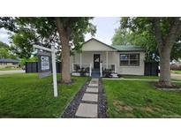 Charming single-story home with a well-maintained front yard and inviting walkway at 6005 E Iowa Ave, Denver, CO 80224