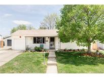 Charming single-story home with a well-manicured lawn and lush landscaping at 1634 S King St, Denver, CO 80219