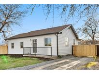 Charming home with a well-maintained lawn, dark trim, and a cozy front porch at 3073 S Elati St, Englewood, CO 80110