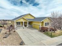 Charming one-story home with welcoming front porch, stone accents, and a spacious driveway at 15004 Verbena St, Thornton, CO 80602