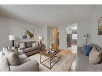 Inviting living room featuring a stylish gray sofa set, wooden coffee table, and bright, neutral tones at 1060 S Parker Rd # 9, Denver, CO 80231
