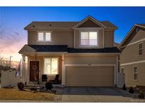 Charming two-story home featuring a well-maintained lawn and a two-car garage at 21088 Randolph Pl, Denver, CO 80249