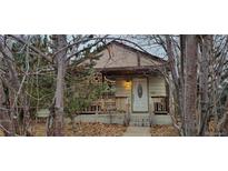 Charming house with a white front door and small porch at 1238 Rosemary St, Denver, CO 80220