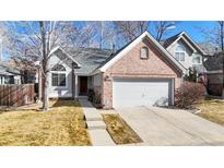 Charming home featuring a brick facade, attached garage, and well-maintained front yard at 2266 S Kenton St, Aurora, CO 80014