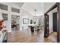 Open concept dining room, seamlessly connected to living spaces, filled with natural light at 1053 Snow Lily Ct, Castle Pines, CO 80108