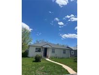 View of charming single-story home with a well-maintained lawn and inviting walkway under a bright blue sky at 1132 Moline St, Aurora, CO 80010