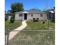 Charming single-story home featuring a well-maintained lawn and quaint front porch at 1132 Moline St, Aurora, CO 80010