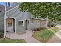 Charming home featuring a well-maintained lawn and a sidewalk leading to the front door at 1915 S Balsam St, Lakewood, CO 80227