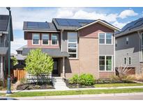 Beautiful two-story home featuring solar panels, landscaping, and a welcoming front entrance at 9007 E 60Th Ave, Denver, CO 80238