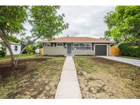 Charming ranch-style home with a well-maintained front yard and a driveway leading to the garage at 740 Moline St, Aurora, CO 80010