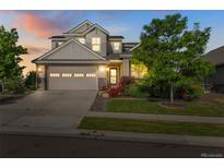 Charming two-story home with a well-manicured lawn and a two-car garage at sunset at 5077 W 108Th Cir, Westminster, CO 80031