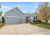Charming two-story home with a well-maintained lawn and a two-car garage, perfect for Gathering living at 12136 Desert Hills St, Parker, CO 80138