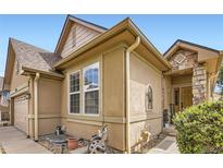 Charming home exterior with stucco siding, stone accents, and a welcoming entrance at 6694 S Rome St, Aurora, CO 80016