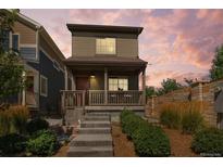 Charming home with a covered porch and well-maintained landscaping at 12794 Tamarac St, Thornton, CO 80602