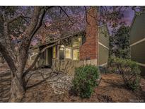 Charming townhome exterior features a brick chimney and welcoming front entrance and rock garden at 2005 S Helena St # G, Aurora, CO 80013