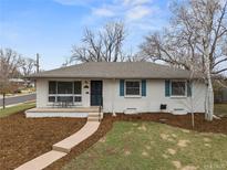 Charming ranch-style home with white exterior, blue shutters, and a welcoming front porch at 2600 S Cherry St, Denver, CO 80222