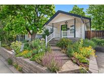 Charming home with a well-manicured yard and inviting front porch at 3052 S Logan St, Englewood, CO 80113