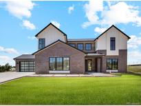 Stunning two-story home featuring mixed brick and siding with a sleek black metal roof and black window trim at 5145 S Kearney Ct, Greenwood Village, CO 80111
