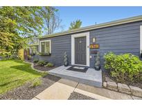Charming home entrance with a gray door, manicured bushes, and clear, bright house number at 2540 Kendall St, Edgewater, CO 80214