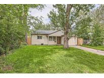 Charming home featuring a well-manicured front yard and mature trees creating a peaceful curb appeal at 2565 S Gaylord St, Denver, CO 80210