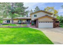 Charming two-story home featuring a manicured lawn and a two-car garage at 8866 E Easter Ave, Centennial, CO 80112