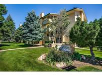 Attractive apartment building with manicured lawn and mature trees on a beautiful sunny day at 3035 Oneal Pkwy # 35T, Boulder, CO 80301