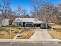 Charming single-story home with a covered front porch and attached carport at 3145 S Ash St, Denver, CO 80222